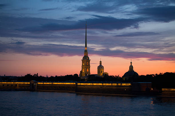 Evening panorama of the Fontanka river and old residential buildings in the historical center of Sankt Petersburg, Russia.  Clear cloudy sky and evening yellow light