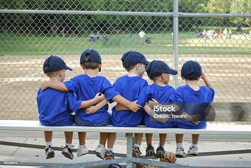 i love my team five little boys put their arms around each other befor their baseball game Child Stock Photo