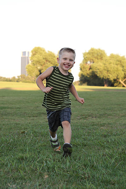 Little boy running stock photo