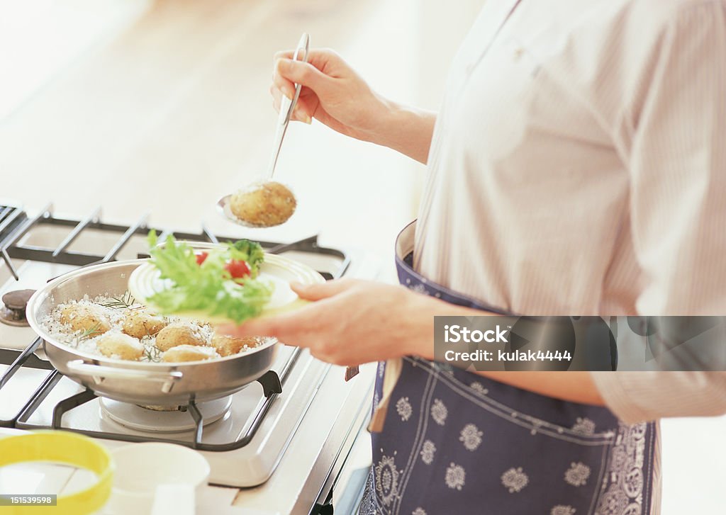 woman on kitchen woman on kitchen cooking Adult Stock Photo