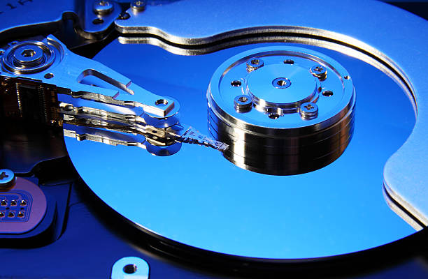 Close-up view of the opened hard disk drive Close-up view of the opened hard disk drive(toned in blue mode) hard drive photos stock pictures, royalty-free photos & images