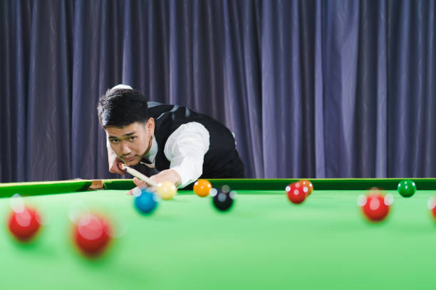 istock Asian young man aiming snooker ball with professiona 1515410295