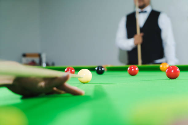 istock Blurred camera angle from a snooker player with an opponent in front of him. 1515410301