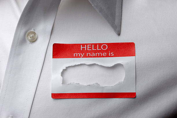 Identity Theft Close up of name tag on shirt with name torn out hello stock pictures, royalty-free photos & images