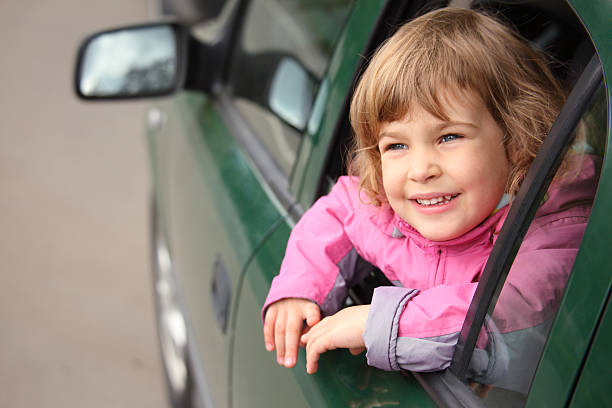 istock Girl in the car looking throw window 151543918