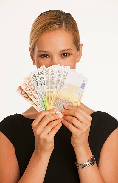 businesswoman holding up Euros stock photo