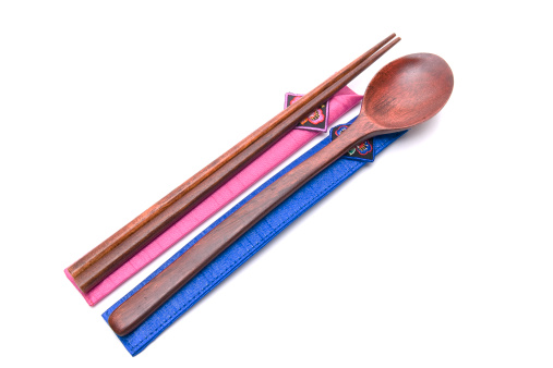 wooden chopsticks and spoon with 2 vibrant pouches