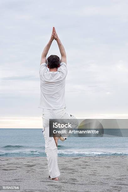 Man Doing Yoga On Beach Stock Photo - Download Image Now - 30-39 Years, Adult, Adults Only