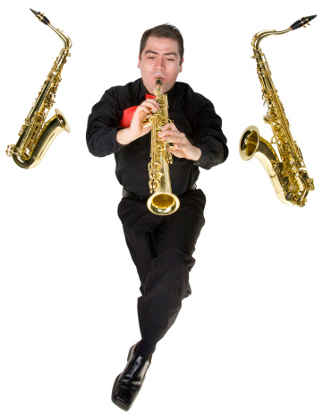 A latino saxophone player with his instruments isolated on white.