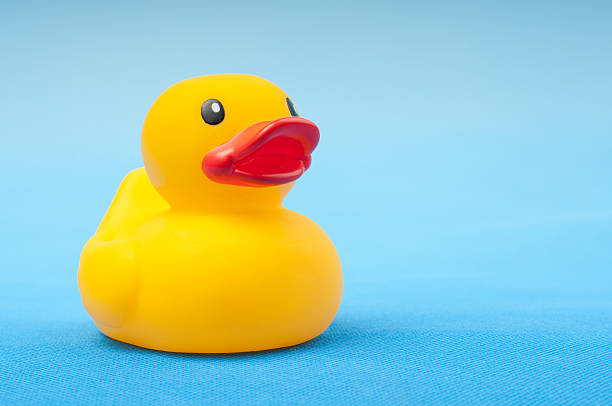 istock yellow rubber duck on blue background water 151546709