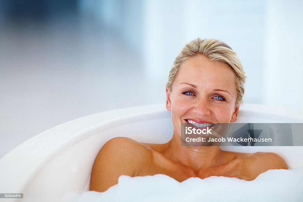て幸せな成熟した女性のバスルーム - 風呂のロイヤリティフリーストックフォト