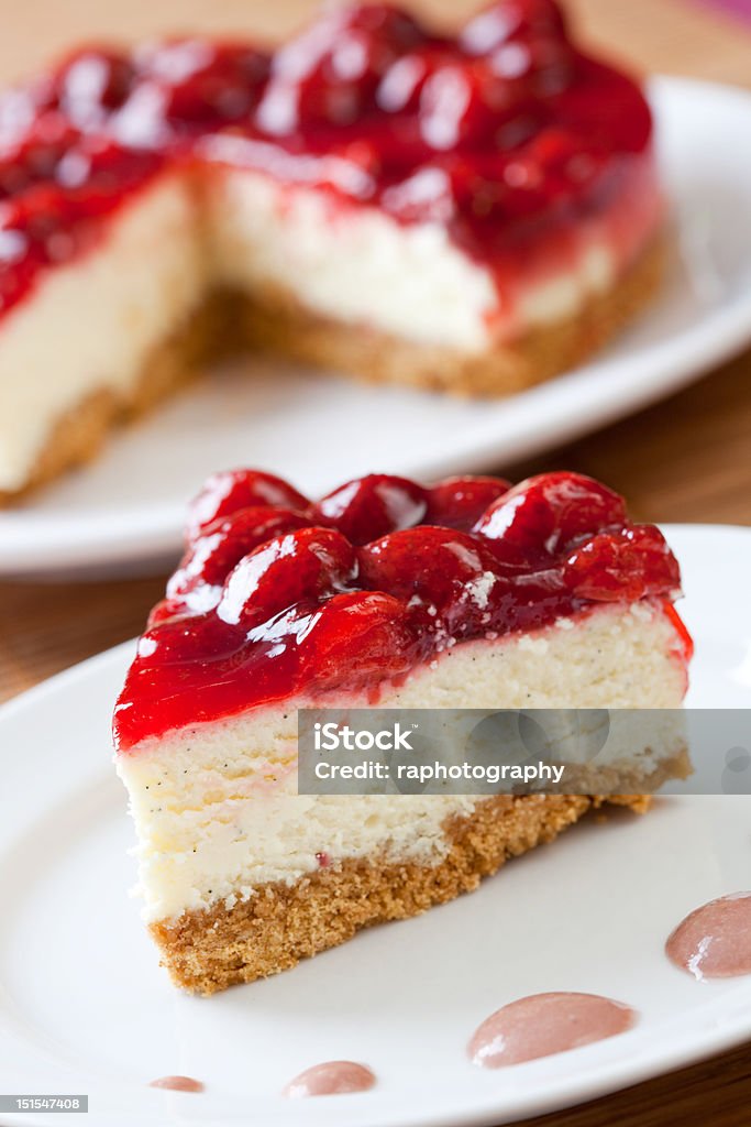 Slice of delicious strawberry cheese cake Slice of delicious strawberry cheese cake with a cake in the background Strawberry Cheesecake Stock Photo