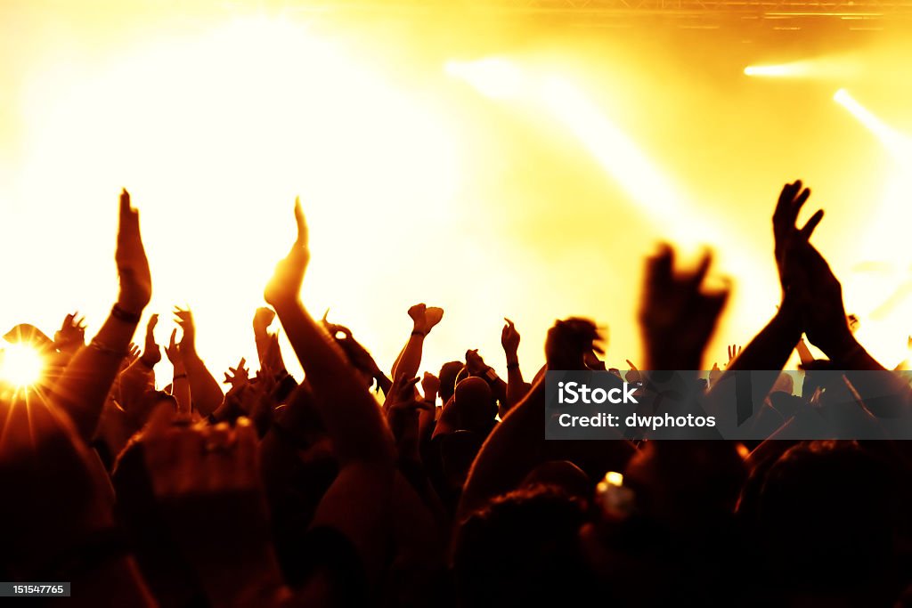 Silhouettes of a cheering crowd Focus at the first(last) row of people. Adolescence Stock Photo