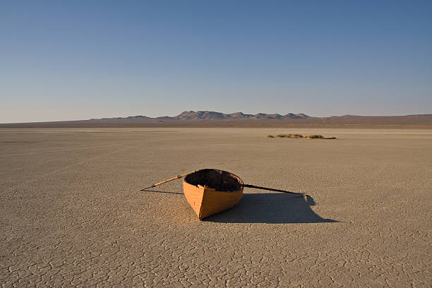 row boat in desert orange row boat in a dry lake bed lake bed stock pictures, royalty-free photos & images