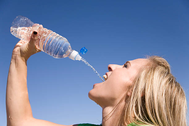 istock Woman squirts water into mouth 151548462