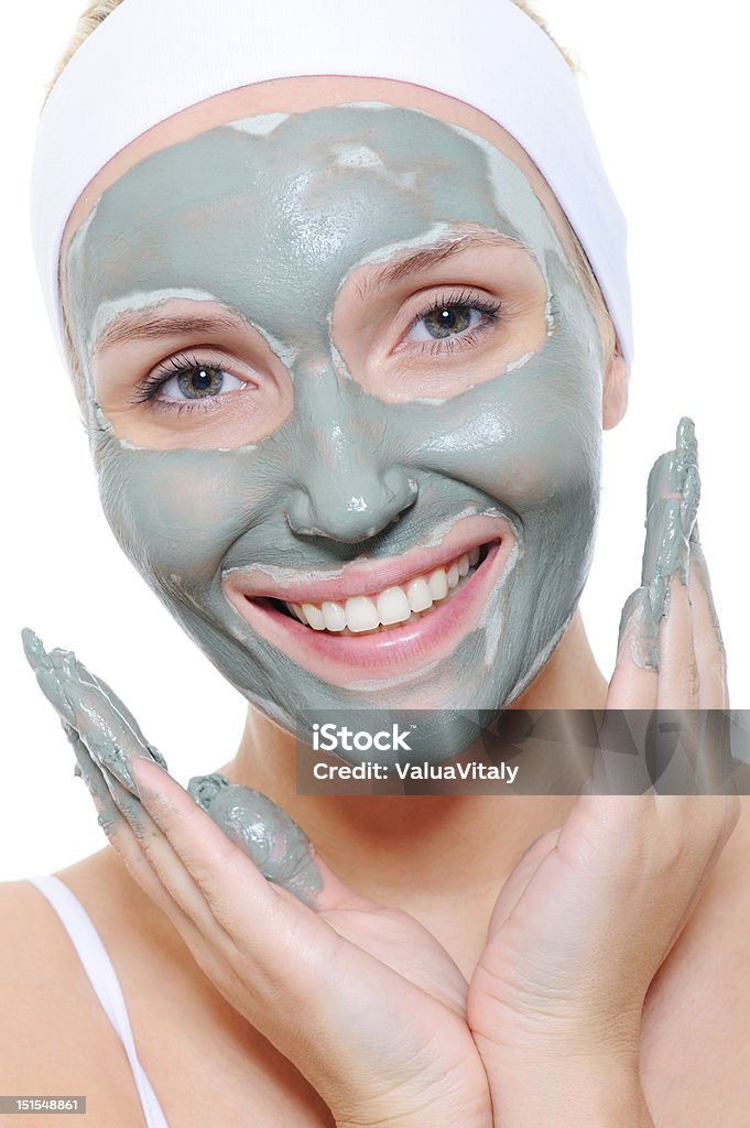 woman applying the cosmetic mask young happy woman applying the cosmetic mask of clay on her face 20-29 Years Stock Photo