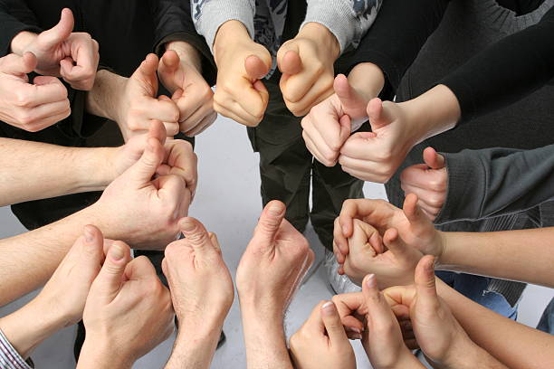 istock A circle created with twenty hands in the thumbs up signal 151549006