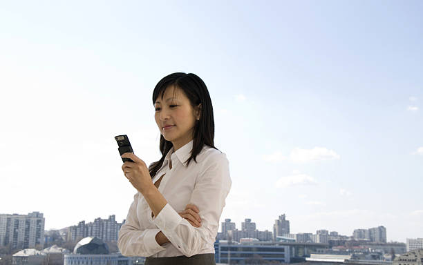 asian businesswoman with mobile phone stock photo