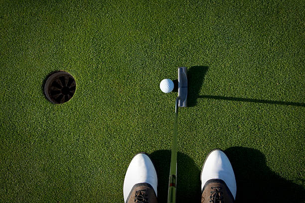 Golfer's eye view of a putt A golfer about to tap in a easy putt. putting green stock pictures, royalty-free photos & images