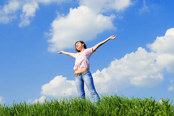 istock happy young woman dreams to fly on winds 151551108
