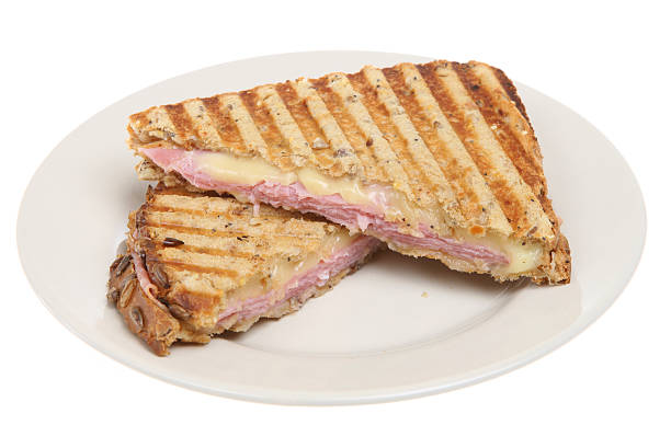 A ham and cheese panini served on a white plate Ham & cheese toasted pressed sandwich or panini toasted sandwich stock pictures, royalty-free photos & images