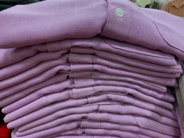 istock stack of folded pink shirt in cloths store display 1515527744