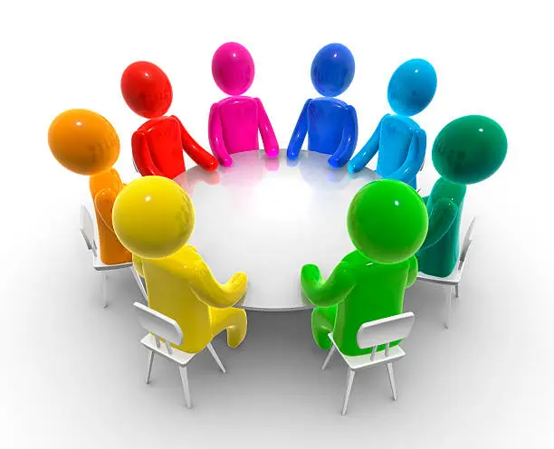 Group of man sitting around an empty table.