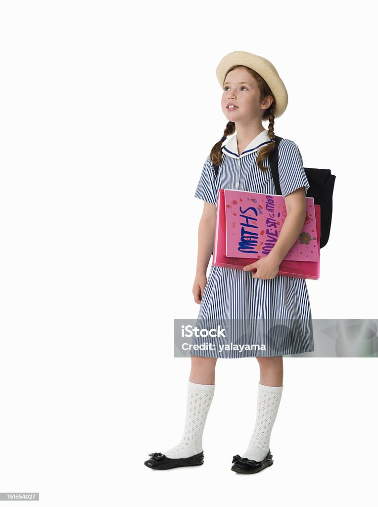 Jeune fille en uniforme tenant école des vêtements de travail - Photo de Petites filles libre de droits