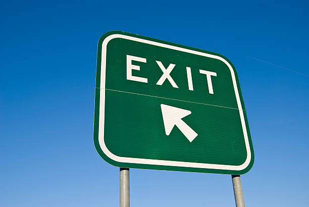 Exit Sign on Freeway A green "Exit" sign on the freeway. exit sign stock pictures, royalty-free photos & images