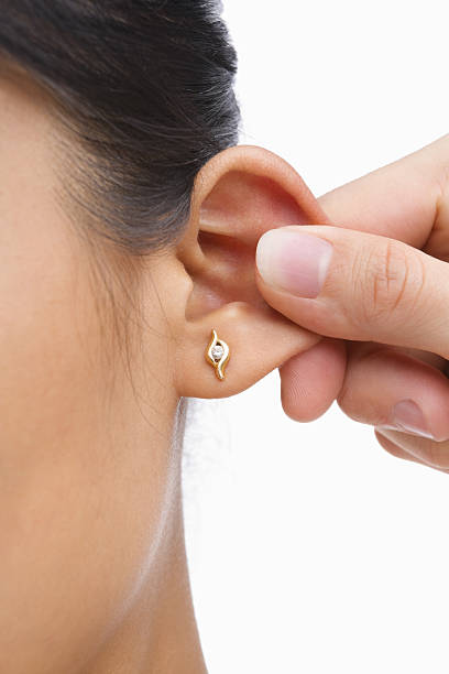 istock Finger pinching woman's ear 151554426