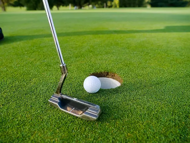 putting on the golf green, golf club has place for logo