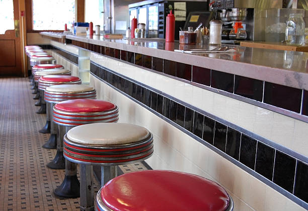 Retro Diner An old-fashioned diner with a tile floor and art deco style bar stools. 1950s diner stock pictures, royalty-free photos & images