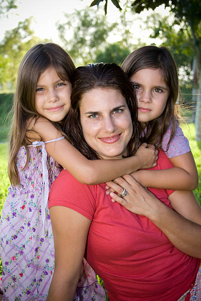 istock happy mother with her girls 151555819