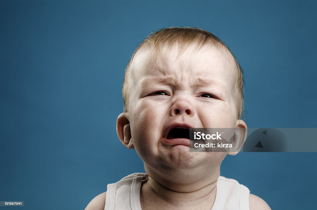 Baby crying Photo of nine month baby crying, isolated Crying Stock Photo