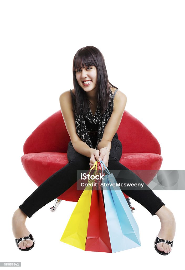 Resting shopper Happy mixed race shopper resting on a lip chair Adult Stock Photo