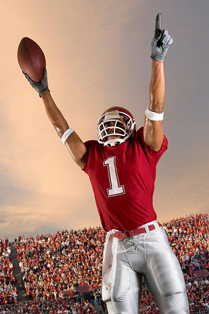 Football Victory Football player celebrates victory wide receiver athlete stock pictures, royalty-free photos & images