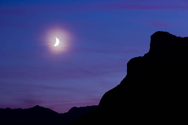 Moon over Silhouette Mountains stock photo