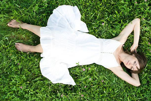 istock Young smiling girl lie in grass 151559275