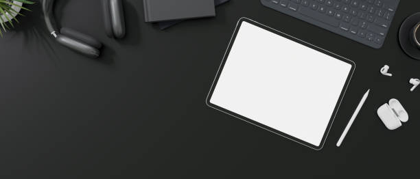 istock Top view of a modern office desk with tablet mockup on black background. 1515598068