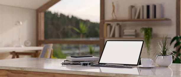 istock A tablet mockup with wireless keyboard on a white tabletop in a minimal white living room. 1515598072