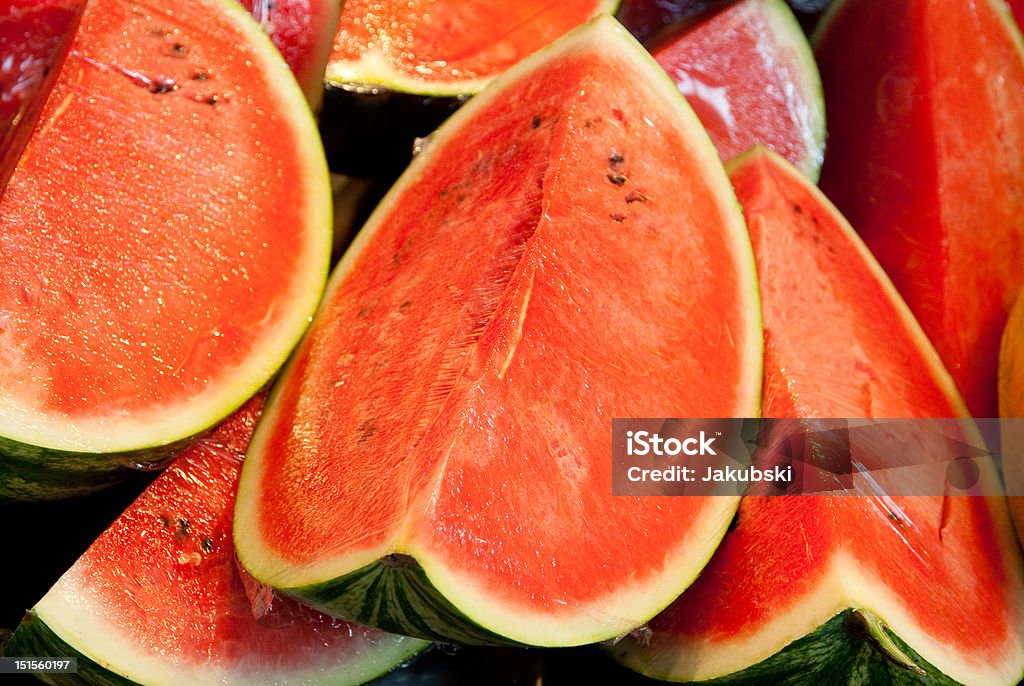 Watermelons on market Bunch of fresh quartered watermelons on market stall Freshness Stock Photo