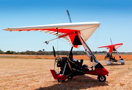 A powered hang glider on the airfield, waiting for a flight