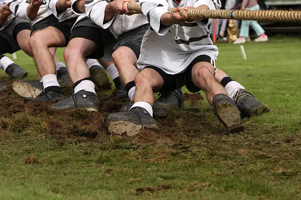 Tug of war is an old traditional game where two teams compete by pulling a rope in a show of strength.