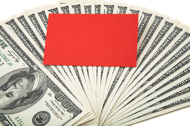 red empty card on a spread of cash stock photo