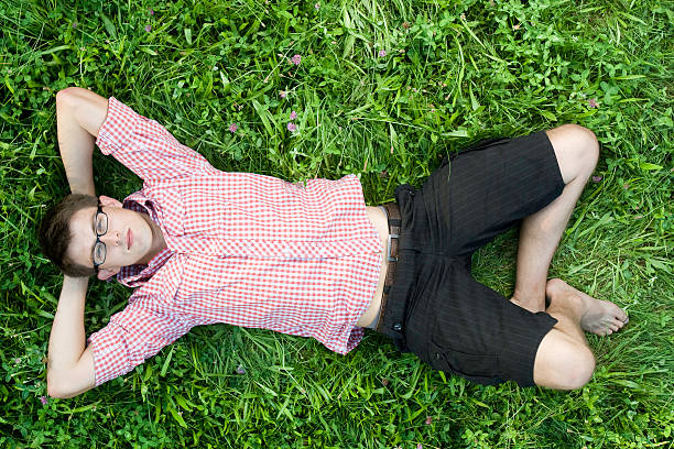 istock Young smiling man lie in grass 151562285