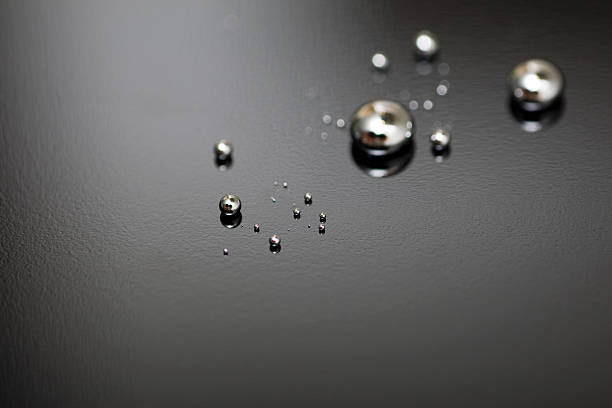 Shiny Mercury Shiny Mercury drops on a pit black background mercury metal stock pictures, royalty-free photos & images