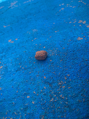pebbles on a blue painted wall