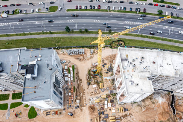 istock yellow crane working on under construction multistory residential building. aerial top view from flying drone. 1515638707