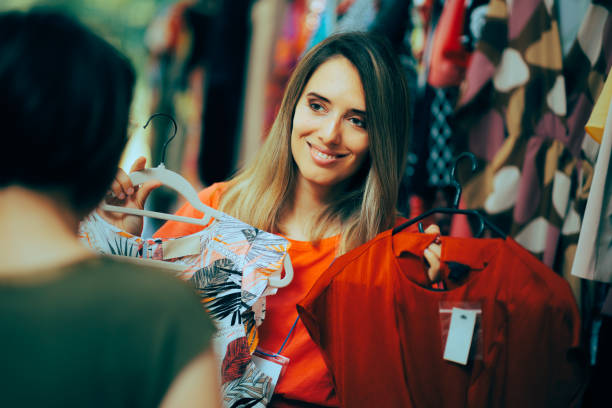 istock Happy Retail Worker Showing a Blouse to her Customer 1515643160