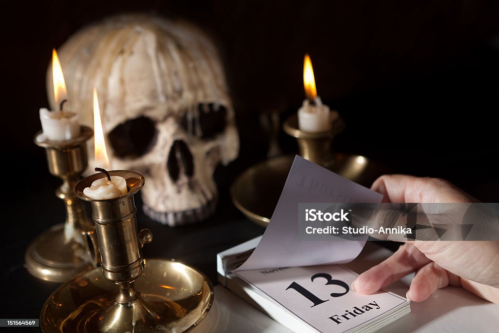 Friday 13th on a calendar Friday 13th on a calendar with candles and a creepy skull Friday the 13th Stock Photo